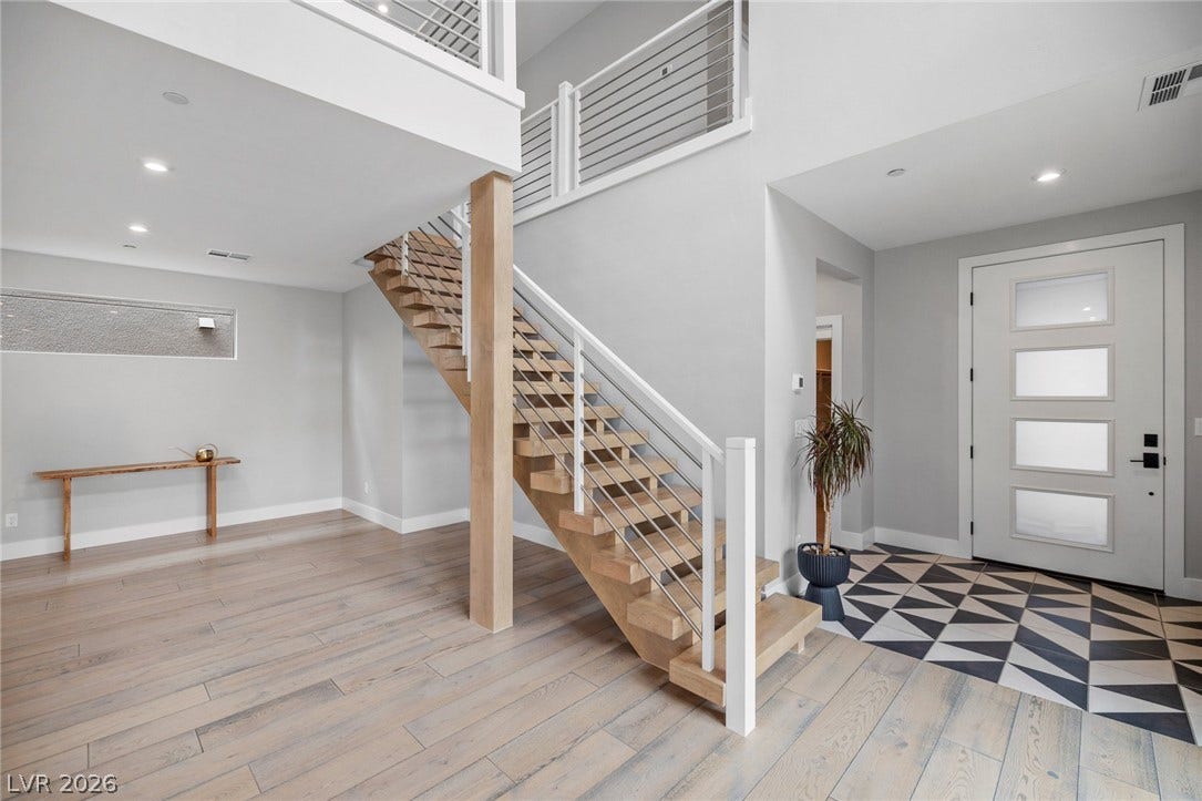 3194 Poplar Crest Court, Henderson, NV 89044 Modern design meets functionality with an inviting open-tread staircase and striking entryway.