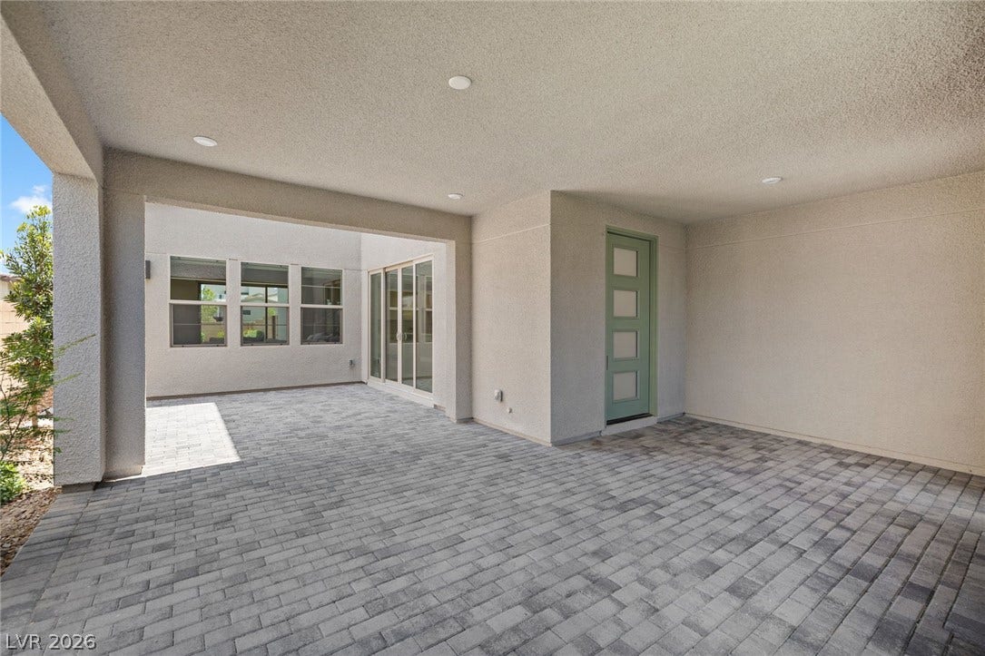 3194 Poplar Crest Court, Henderson, NV 89044 A spacious covered patio features elegant brick pavers and direct access to interior living spaces.