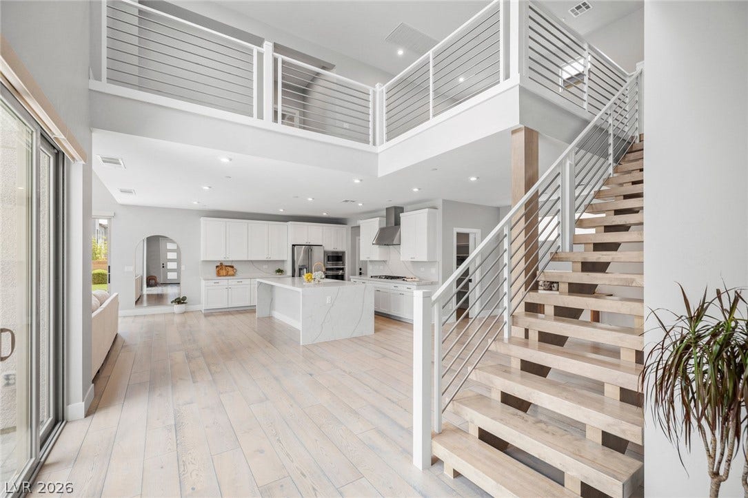 3194 Poplar Crest Court, Henderson, NV 89044 An open-concept living space connects a gourmet kitchen with sleek cabinetry to a bright living area, all illuminated by recessed lighting.
