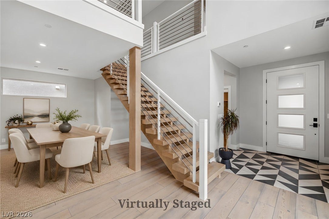 3194 Poplar Crest Court, Henderson, NV 89044 A grand entrance features a modern open-tread staircase alongside a dining area with clean lines.