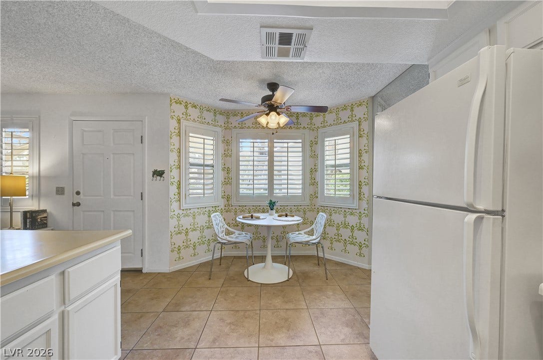 A cozy eat-in kitchen with a charming bay window, perfect for sun-drenched meals.