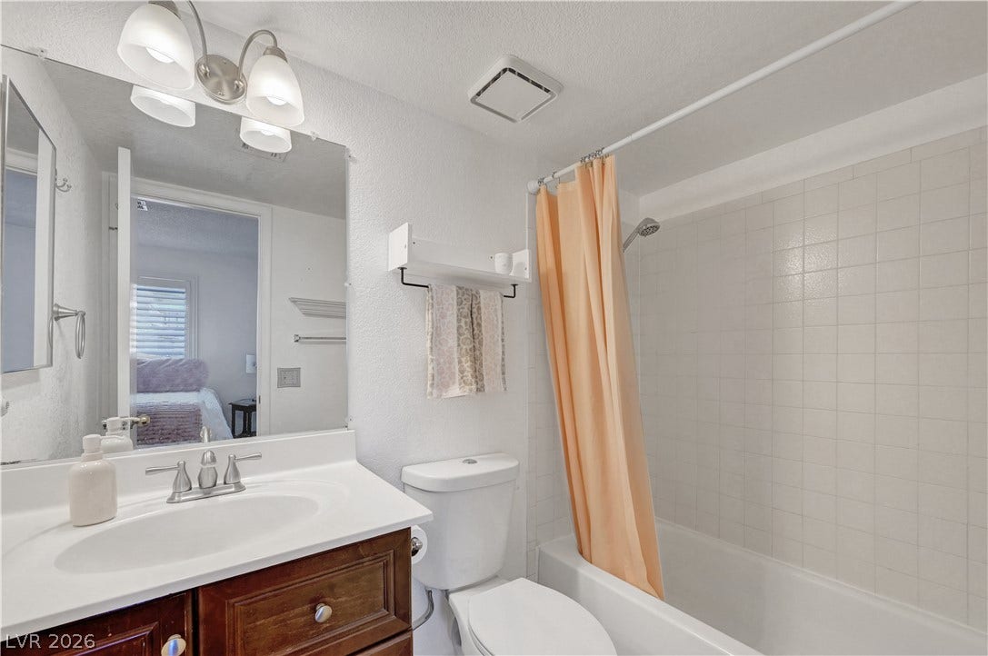 A well-appointed bathroom with a spacious vanity and a combination tub and shower.