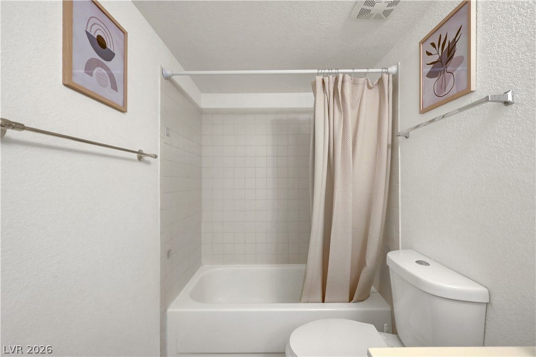 A well-maintained bathroom features a bathtub with tile surround, offering a pristine and functional space.