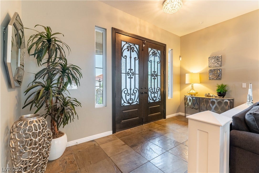 2676 Botticelli Drive, Henderson, NV 89052 Beautiful wrought iron doors with glass inserts welcome you into a foyer featuring elegant slate tile flooring.
