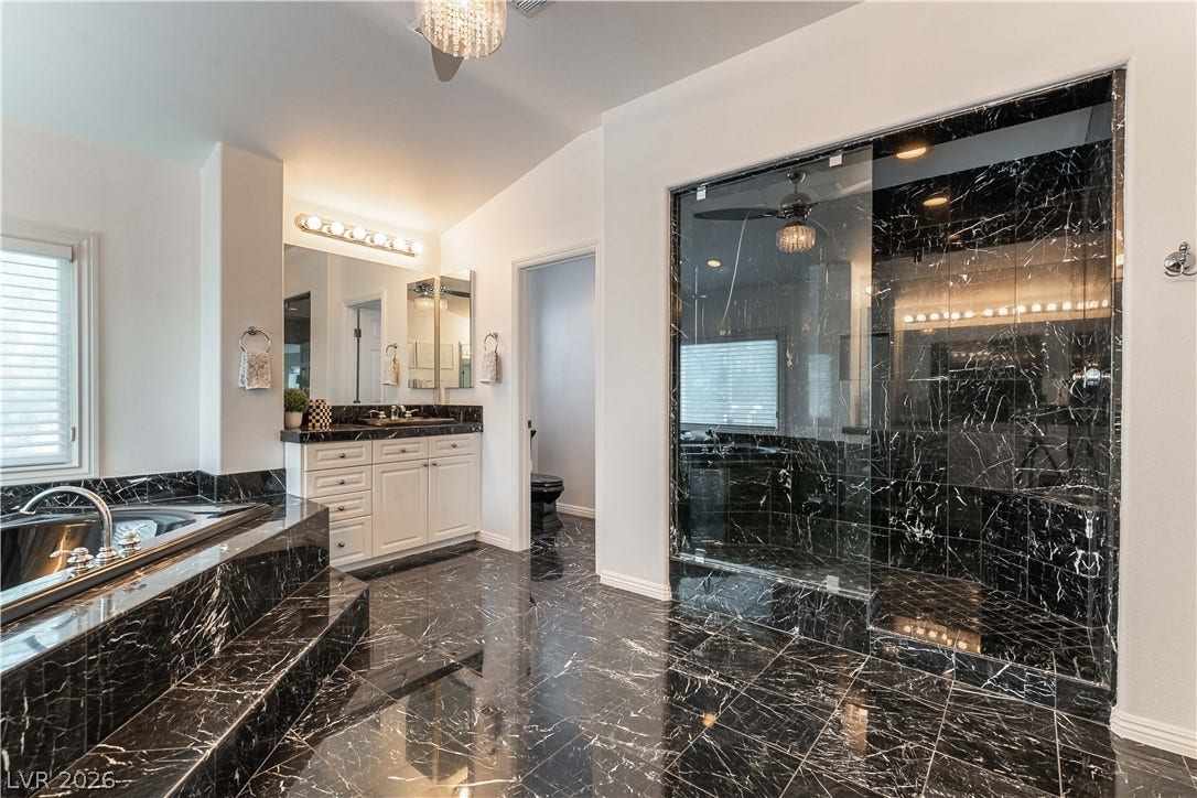 2676 Botticelli Drive, Henderson, NV 89052 Luxurious black marble surfaces create an elegant and seamless primary bathroom aesthetic.