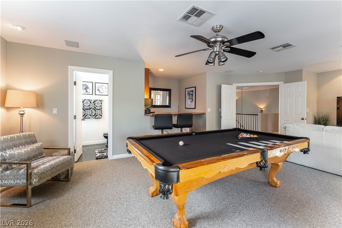2676 Botticelli Drive, Henderson, NV 89052 A vibrant recreation room features area for the pool table that's included, bar area, and inviting sitting space for watching favorite sports.
