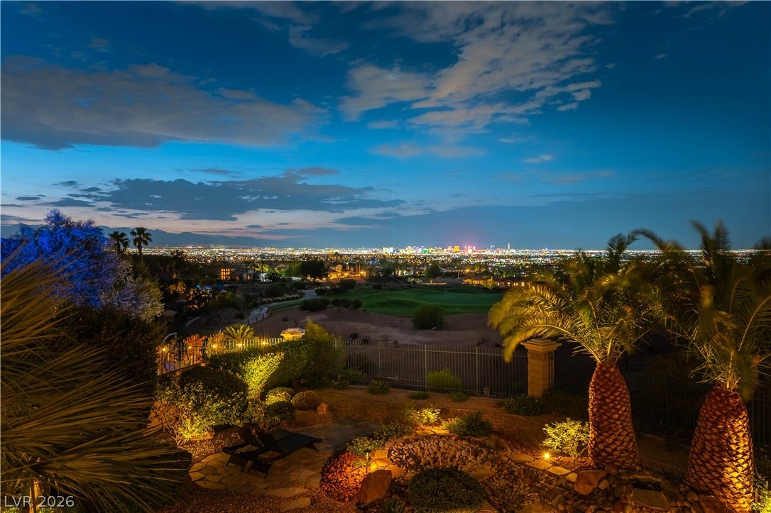 2676 Botticelli Drive, Henderson, NV 89052 Perched above the city lights, this outdoor living space offers illuminated landscaping and distant skyline views.