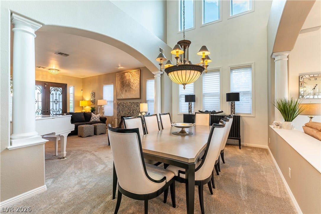 2676 Botticelli Drive, Henderson, NV 89052 A grand dining space with 25' high ceilings connects to an inviting living area, perfect for entertaining.