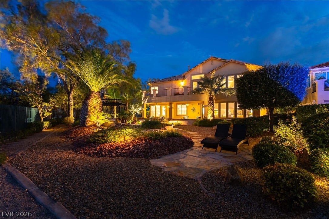 2676 Botticelli Drive, Henderson, NV 89052 Illuminated landscaping enhances this elegant home's evening ambiance and backyard appeal.