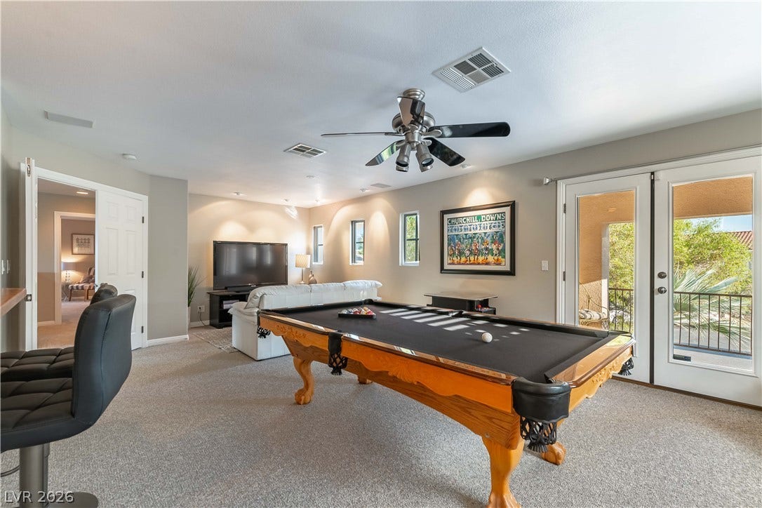 2676 Botticelli Drive, Henderson, NV 89052 A vibrant bonus/2nd family room offers ample space for recreation and relaxation, complemented by large wet bar, surround sound and access to an outdoor balcony.