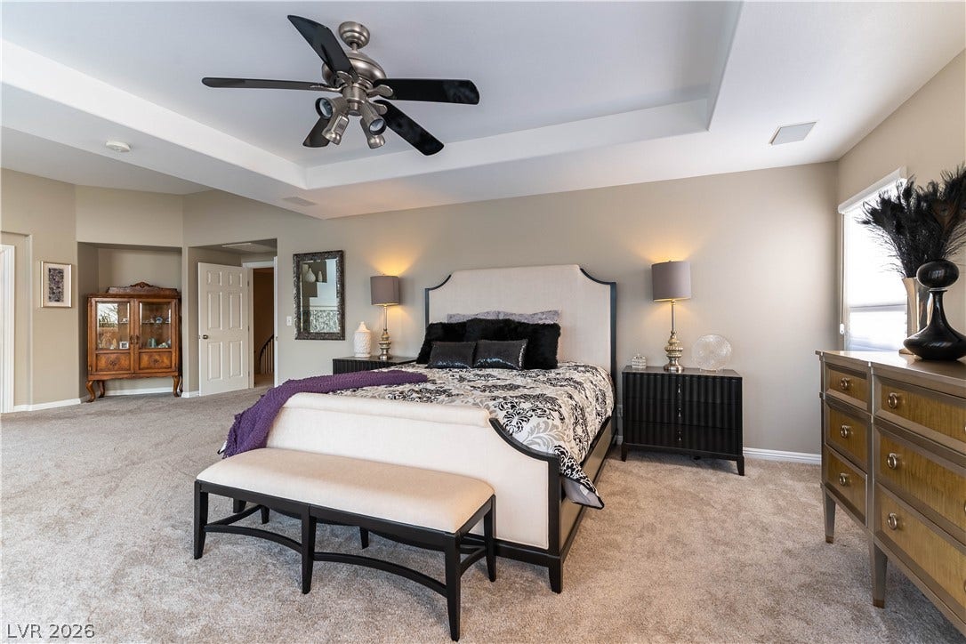 2676 Botticelli Drive, Henderson, NV 89052 A spacious primary bedroom featuring a ceiling fan, recessed lights and elegant recessed ceiling.