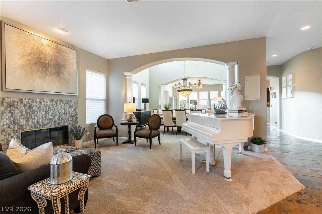 2676 Botticelli Drive, Henderson, NV 89052 Archways gracefully connect a living area with a fireplace to an adjacent elegant dining space with vaulted ceilings.