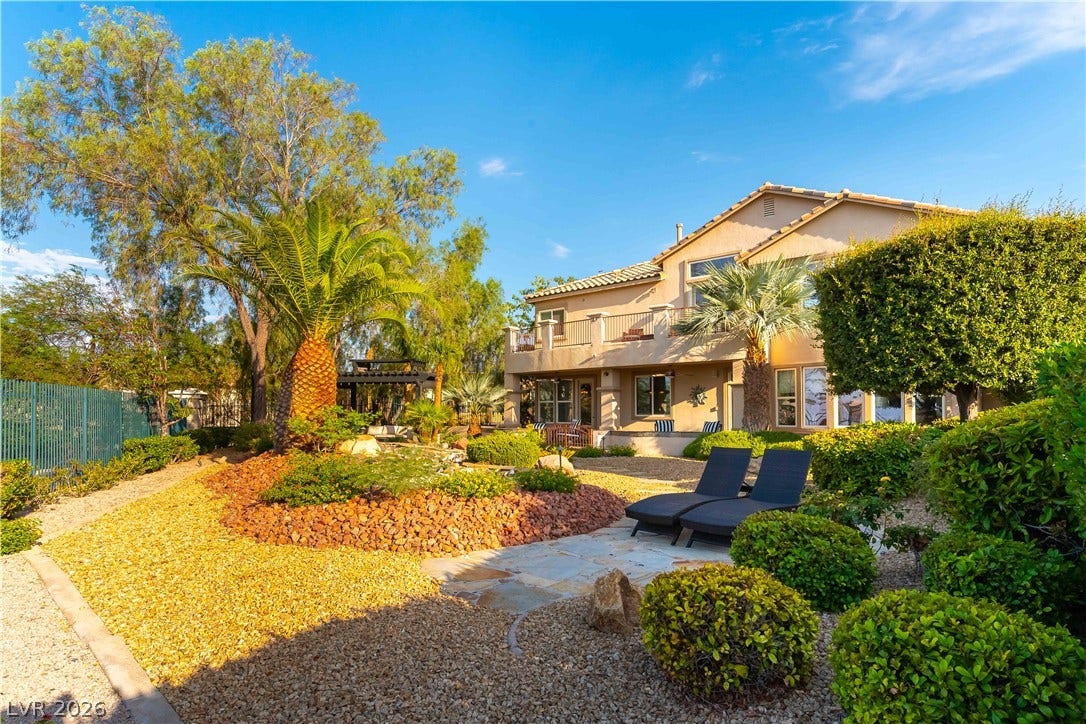 2676 Botticelli Drive, Henderson, NV 89052 Beautiful water feature with waterfall and fountain, lush landscaping and a private yard complement this elegant residence with a large second-story balcony.
