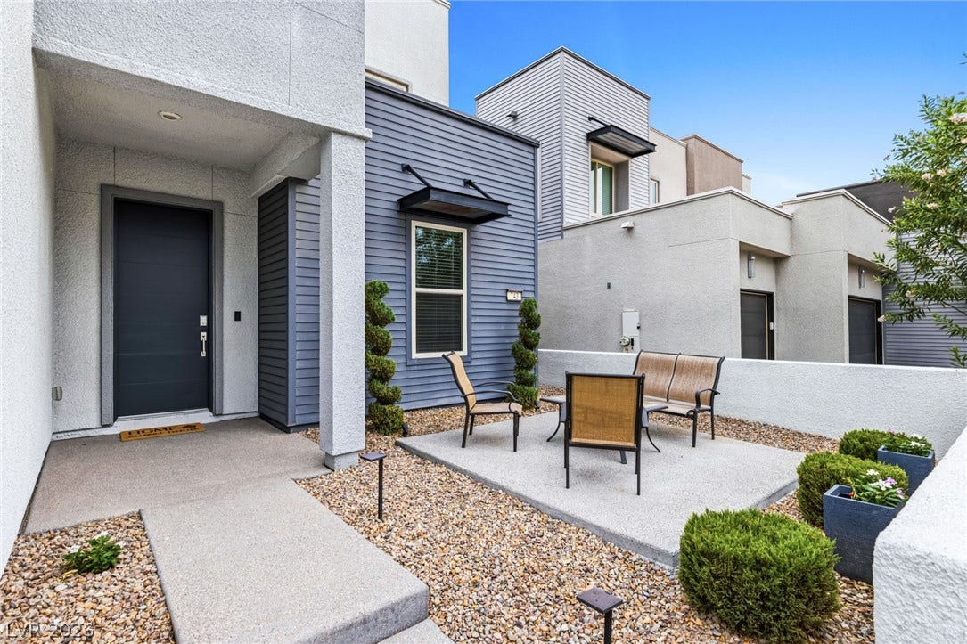 743 Glowing Horizon Street, Henderson, NV 89052 Modern architecture defines this property, showcasing a welcoming entrance and a private patio space.