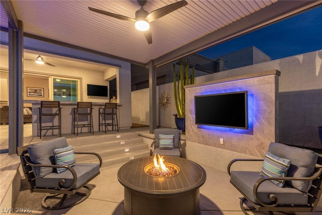743 Glowing Horizon Street, Henderson, NV 89052 An inviting outdoor living space features a cozy fire pit and a stylish bar with integrated seating.