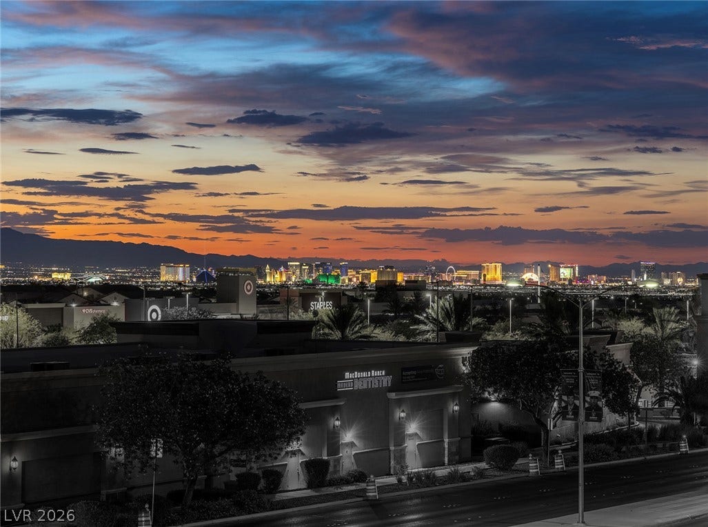 743 Glowing Horizon Street, Henderson, NV 89052 City lights illuminate a captivating desert skyline under a vibrant, twilight sky.