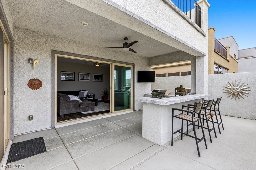 743 Glowing Horizon Street, Henderson, NV 89052 An inviting covered patio offers a complete outdoor kitchen and dining area for alfresco entertaining.