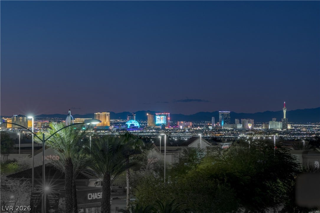 743 Glowing Horizon Street, Henderson, NV 89052 Panoramic nighttime city views illuminate the distant skyline, offering a captivating urban vista.