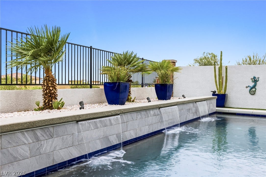 743 Glowing Horizon Street, Henderson, NV 89052 An inviting private pool area with cascading water features and lush desert landscaping.