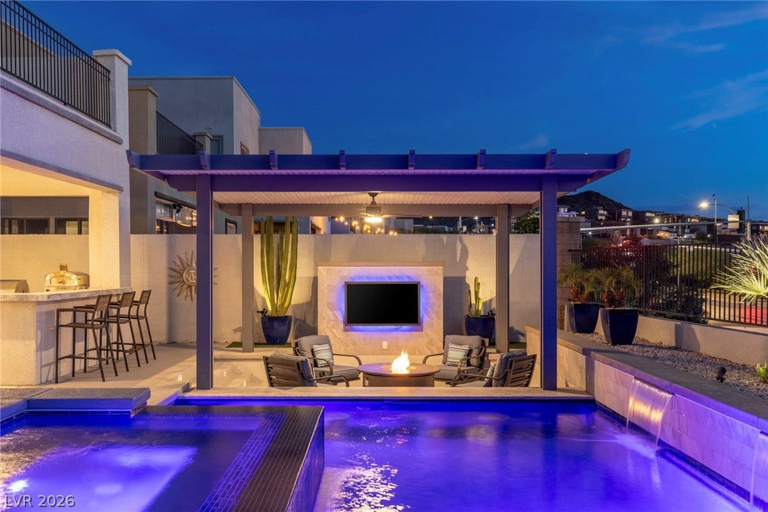743 Glowing Horizon Street, Henderson, NV 89052 An illuminated outdoor space features a modern pergola, refreshing pool, and inviting fire pit for evening gatherings.