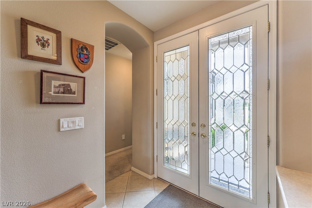 10298 Profeta Court, Las Vegas, NV 89135 Ornate glass doors welcome you into a well-appointed entry with tile flooring.