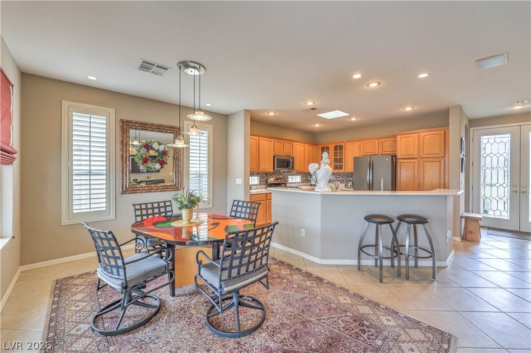 10298 Profeta Court, Las Vegas, NV 89135 An open-concept living space integrates a well-appointed kitchen with an inviting dining area.