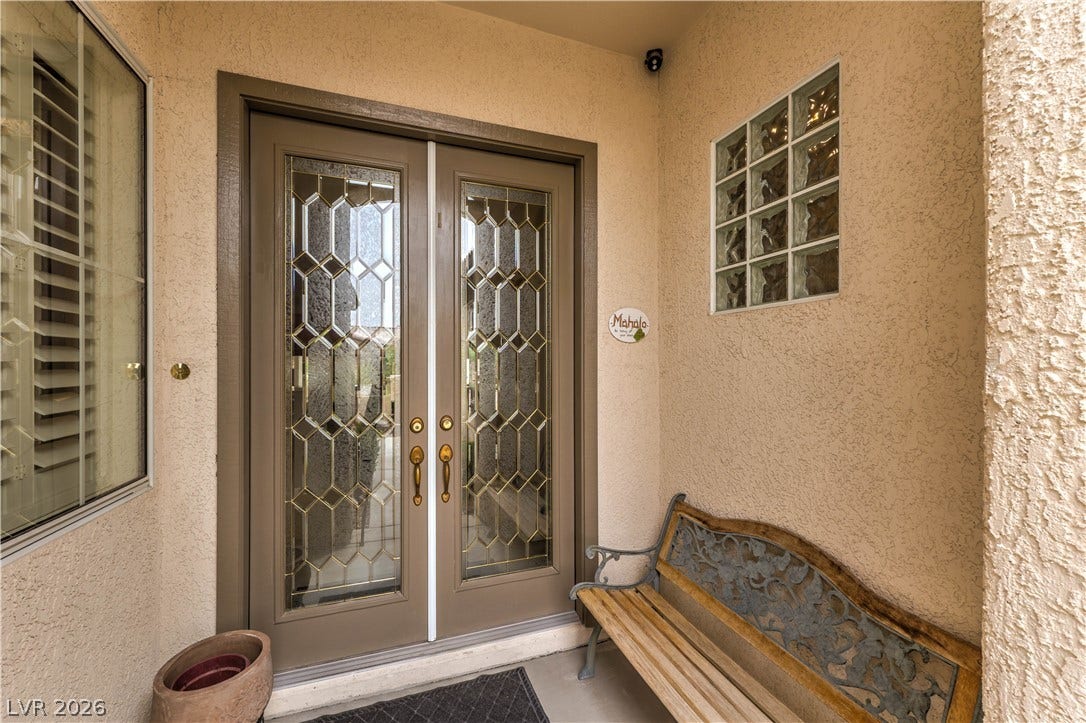 10298 Profeta Court, Las Vegas, NV 89135 Ornate leaded glass doors and a glass block window grace the inviting entry.