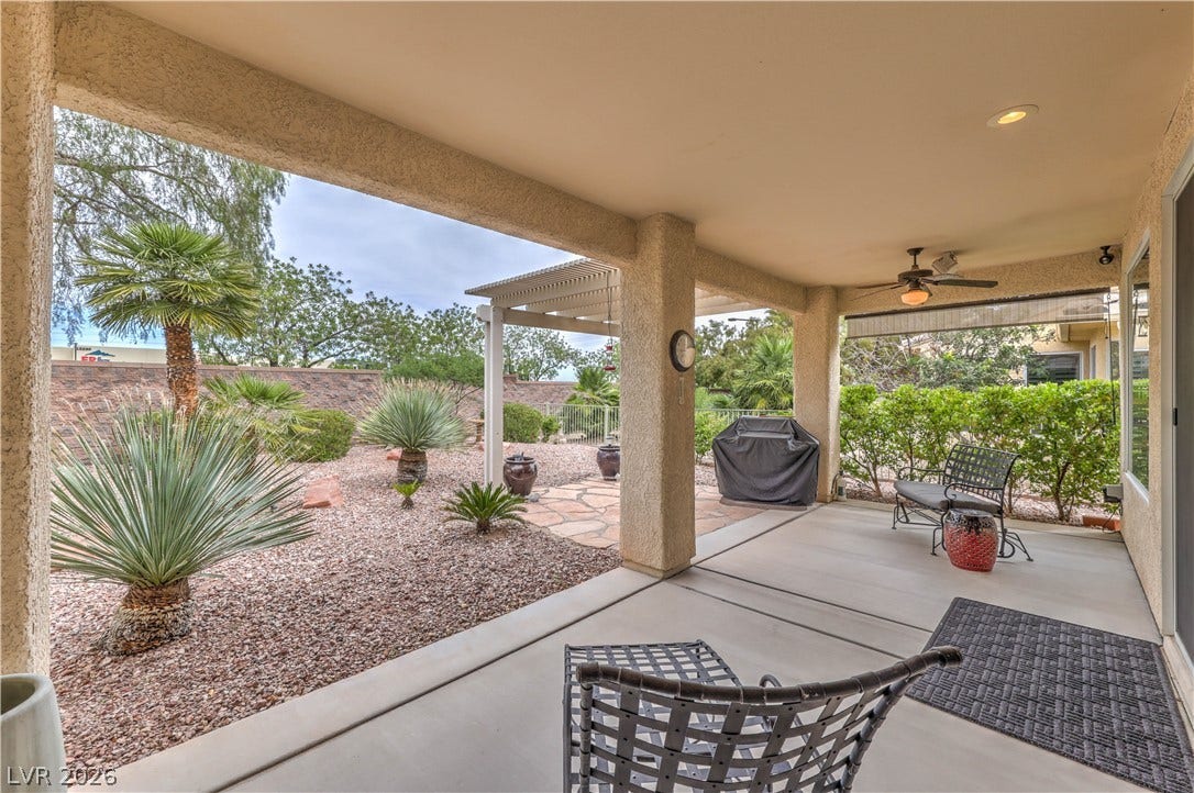 10298 Profeta Court, Las Vegas, NV 89135 A spacious covered patio offers a refreshing retreat with desert landscaping and a built-in outdoor grill.