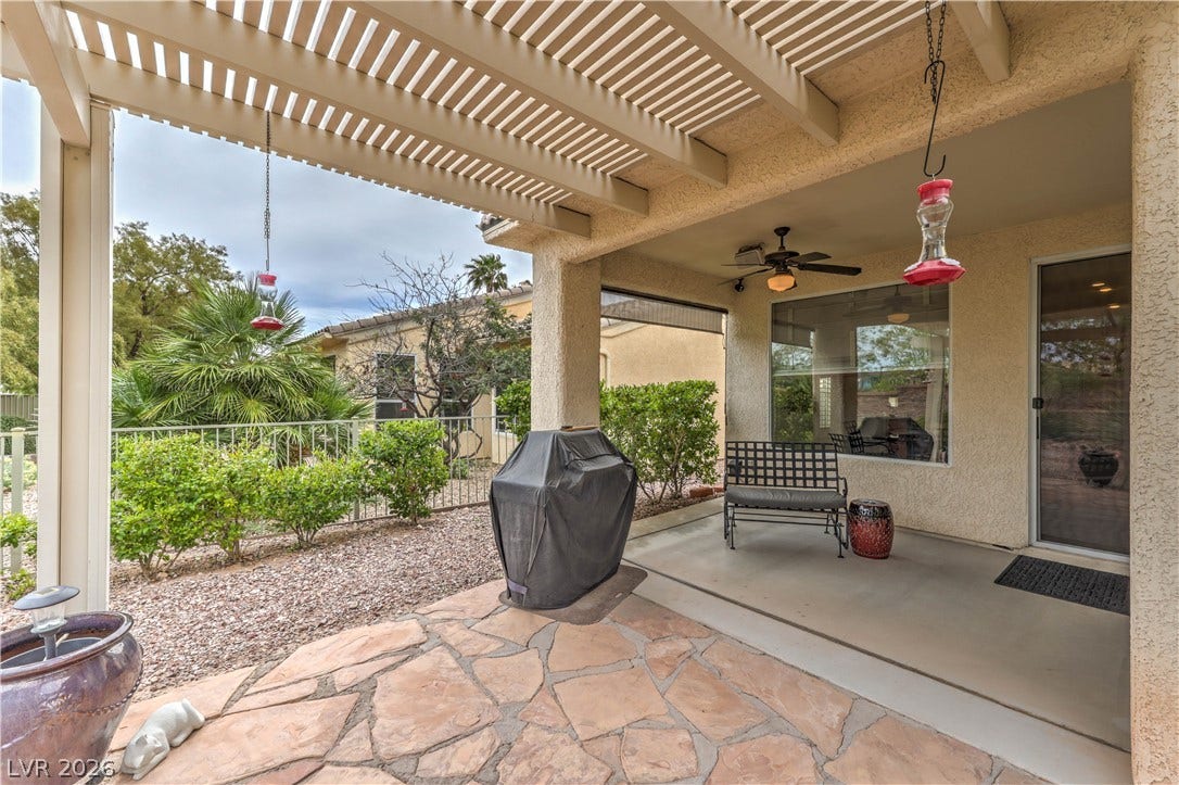 10298 Profeta Court, Las Vegas, NV 89135 A private backyard patio with a slatted pergola invites comfortable outdoor living.