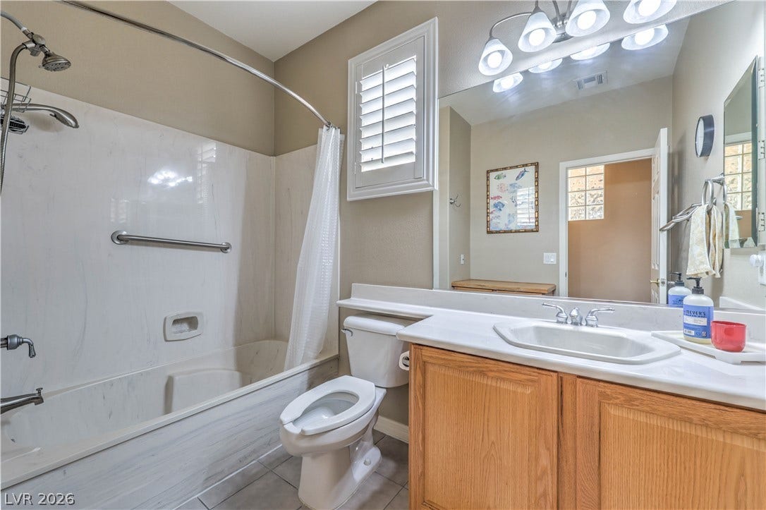 10298 Profeta Court, Las Vegas, NV 89135 Well-lit primary bathroom featuring a bath-shower combo, a single vanity, and a window for natural light.