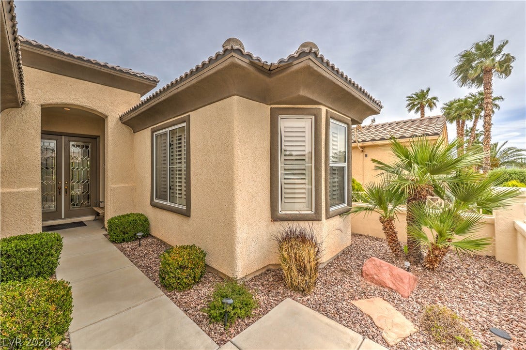 10298 Profeta Court, Las Vegas, NV 89135 A welcoming entry features a leaded glass door and a desert-adapted landscaped garden area.