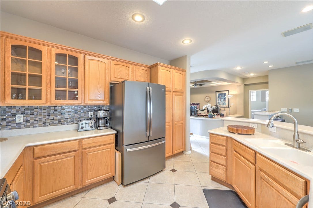 10298 Profeta Court, Las Vegas, NV 89135 A well-appointed kitchen features stainless steel appliances, abundant cabinetry, and a convenient breakfast bar, perfect for culinary endeavors.