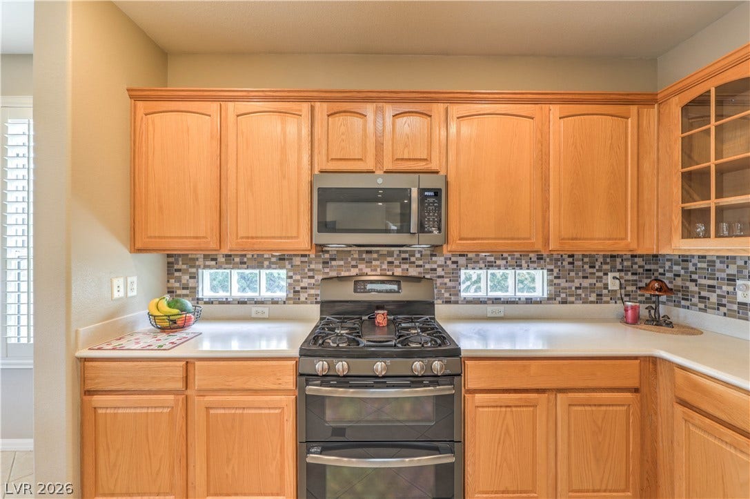 10298 Profeta Court, Las Vegas, NV 89135 Gleaming light wood cabinetry beautifully frames this kitchen's modern stainless steel appliances.
