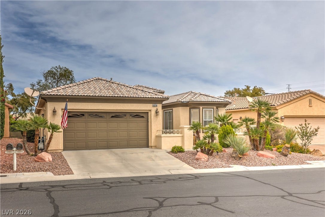 10298 Profeta Court, Las Vegas, NV 89135 A well-maintained desert landscape frames this welcoming residence, featuring a two-car garage and a classic tile roof.