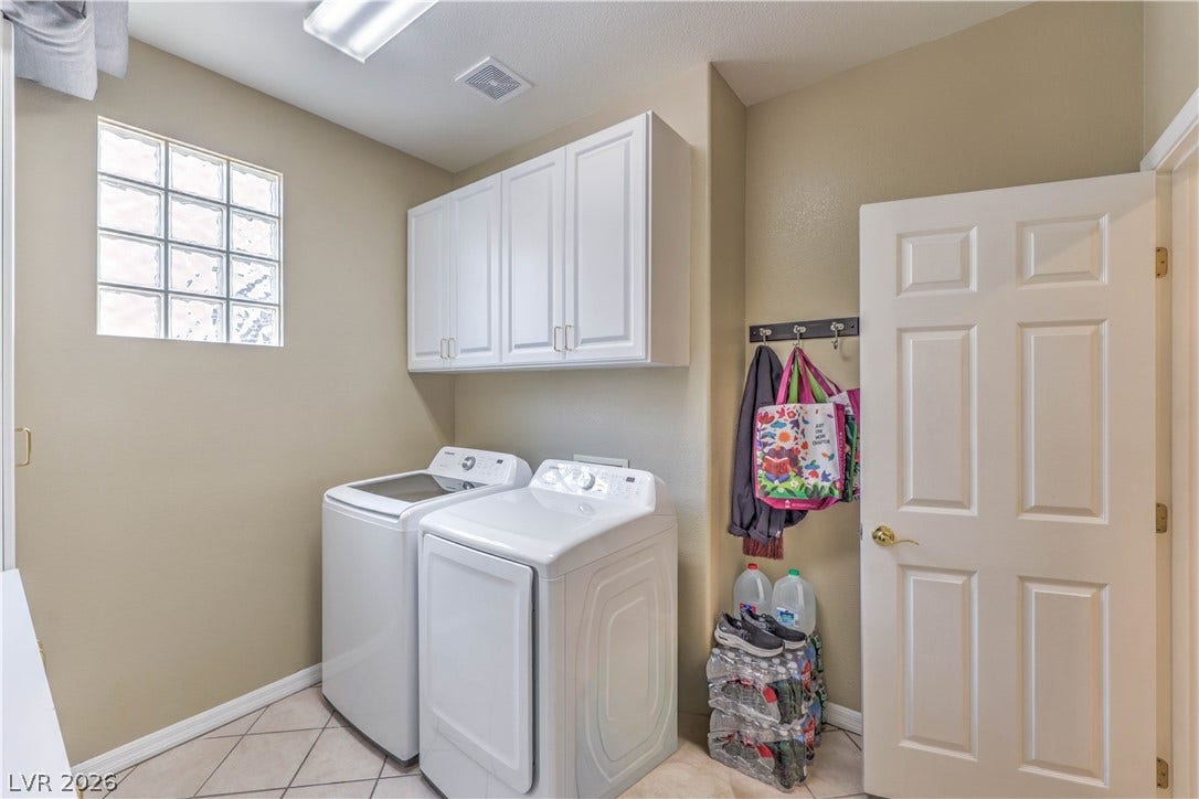 10298 Profeta Court, Las Vegas, NV 89135 Functional laundry space featuring convenient wall-mounted cabinetry and a window for natural light.