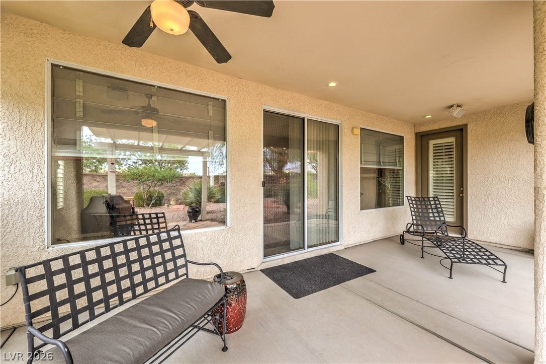 10298 Profeta Court, Las Vegas, NV 89135 A spacious covered patio invites relaxation with ceiling fans and ample outdoor seating.
