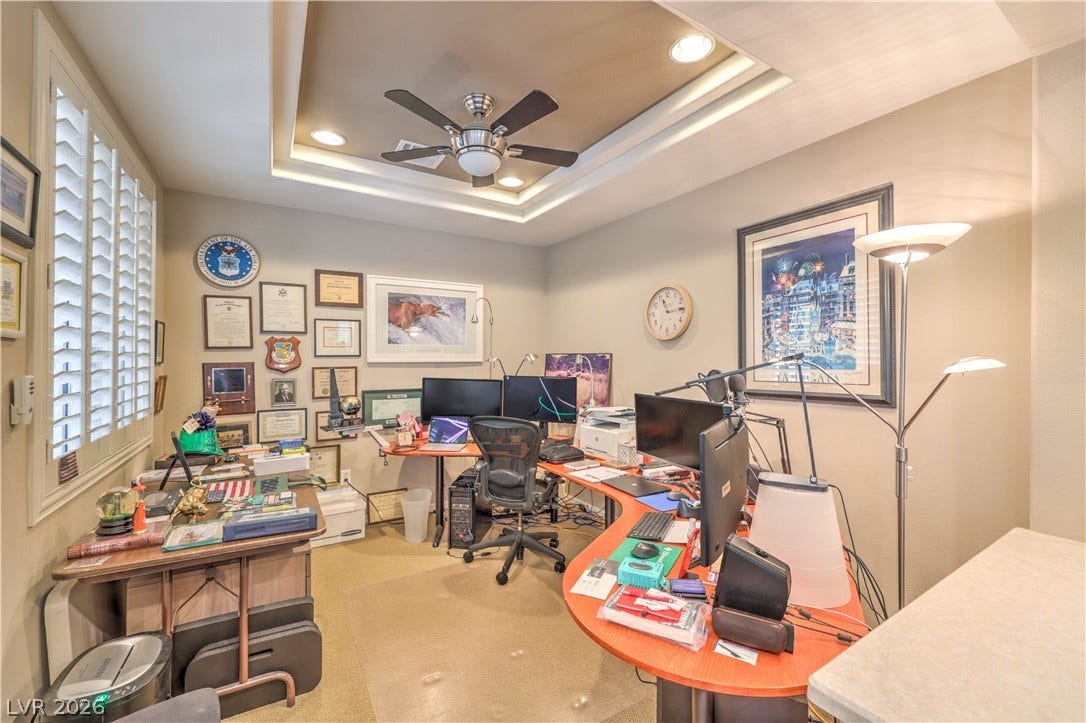 10298 Profeta Court, Las Vegas, NV 89135 An inviting office space features a tray ceiling with recessed lighting and a functional ceiling fan.