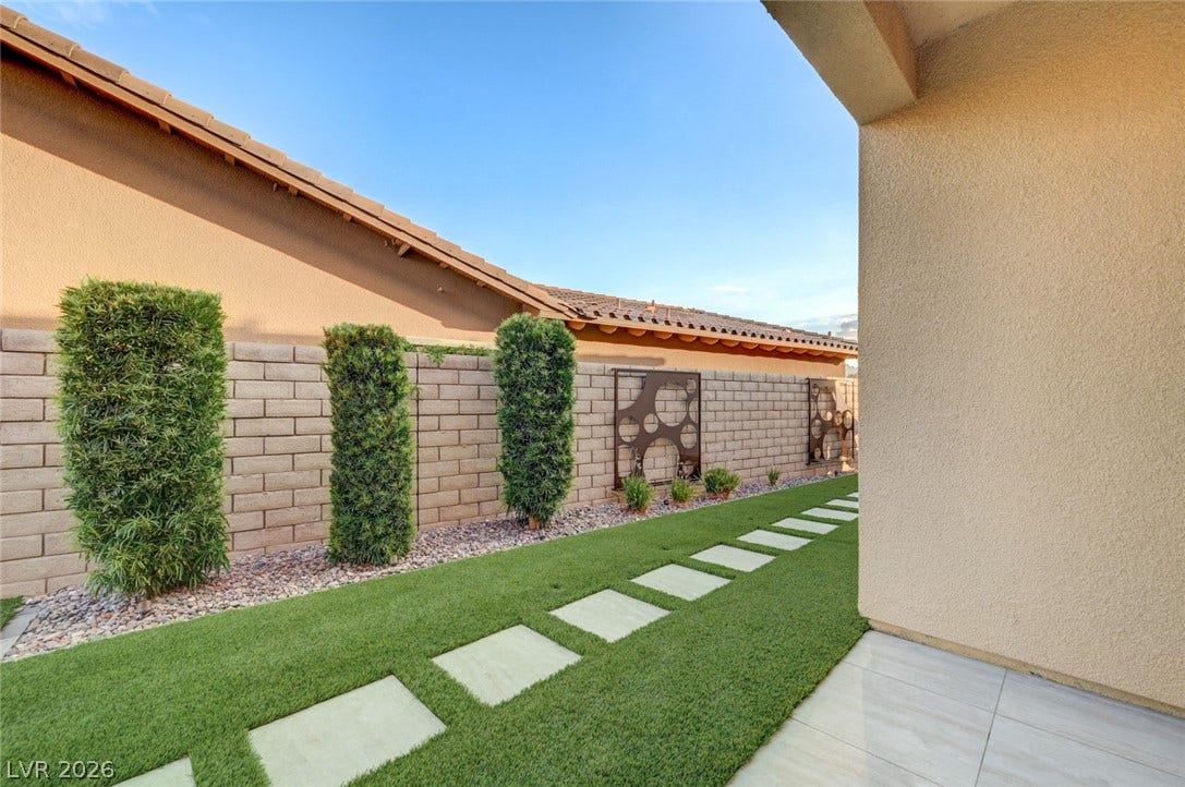 274 Evante Street, Las Vegas, NV 89138 A neatly manicured yard features a stepping stone path, artificial turf, and decorative brickwork.