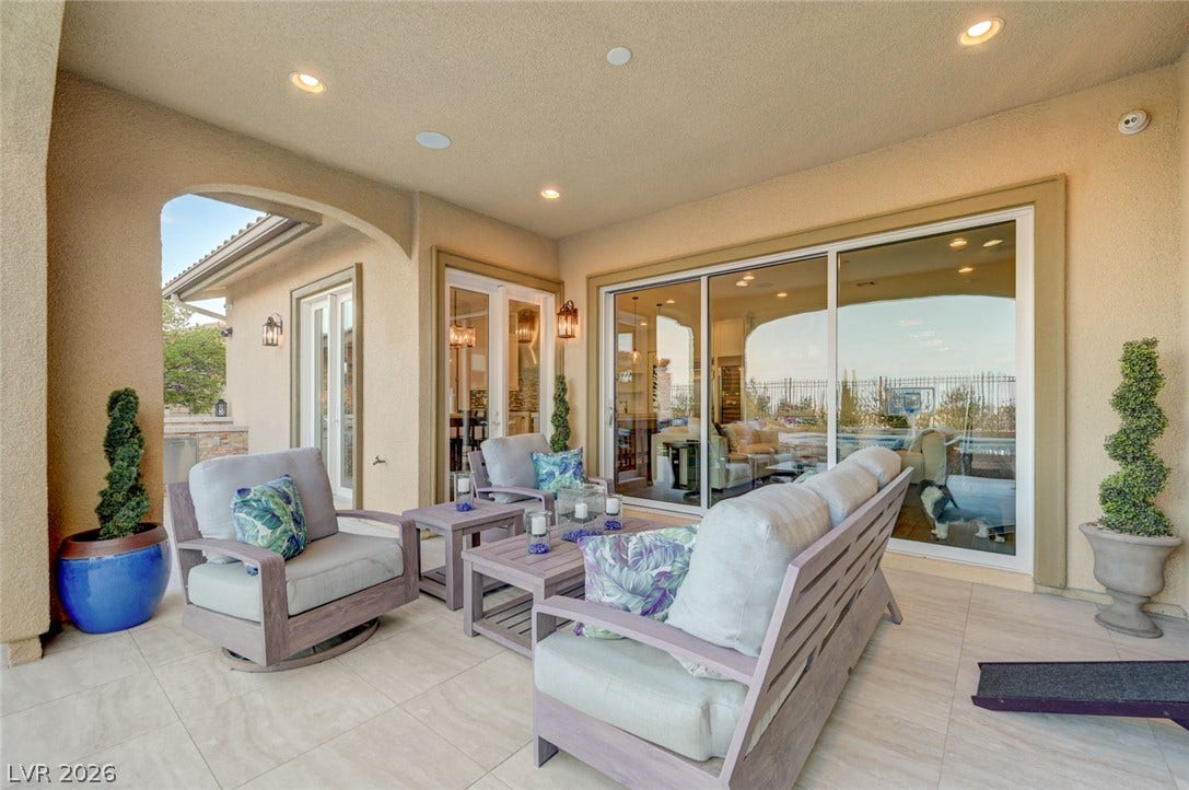 274 Evante Street, Las Vegas, NV 89138 An inviting covered patio featuring tiled flooring extends outdoor living space, perfect for tranquil relaxation or entertaining.
