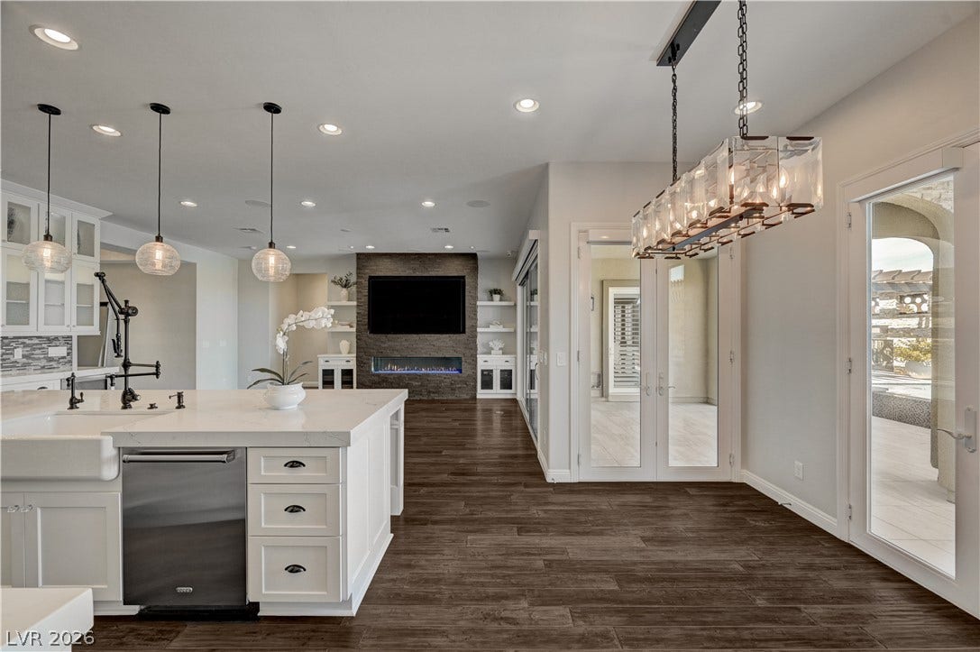 274 Evante Street, Las Vegas, NV 89138 Rich wood plank flooring anchors an open layout connecting the kitchen to adjacent living spaces.