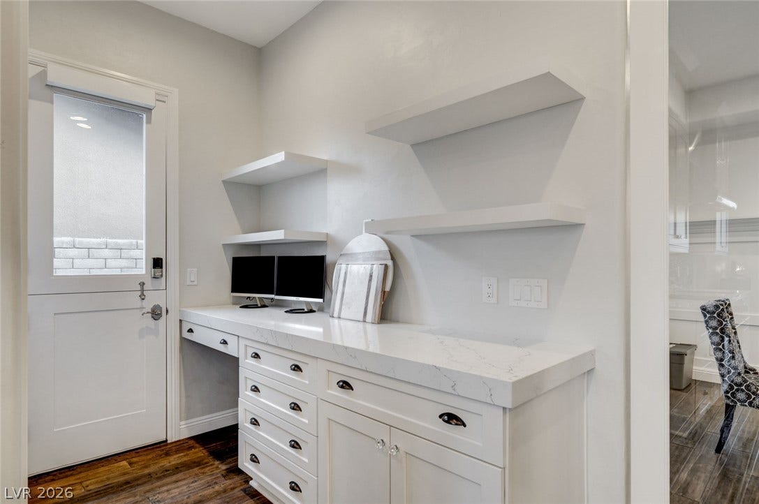 274 Evante Street, Las Vegas, NV 89138 Functional workspace with generous counter space, built-in shelving, and rich hardwood flooring.