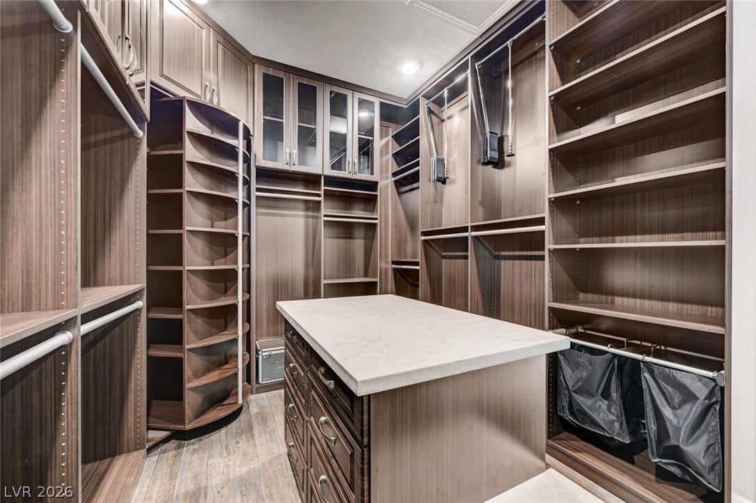 274 Evante Street, Las Vegas, NV 89138 Custom cabinetry and clever storage solutions elevate this sophisticated dressing room.