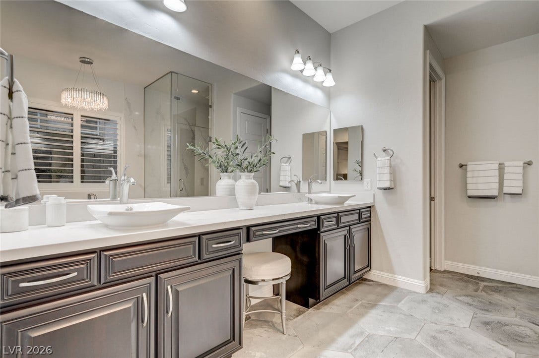 274 Evante Street, Las Vegas, NV 89138 Dual vessel sinks and rich cabinetry create a luxurious, functional bath space.