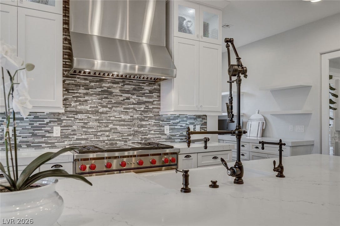 274 Evante Street, Las Vegas, NV 89138 A well-appointed kitchen showcasing a professional-grade range and a chic mosaic tile backsplash.