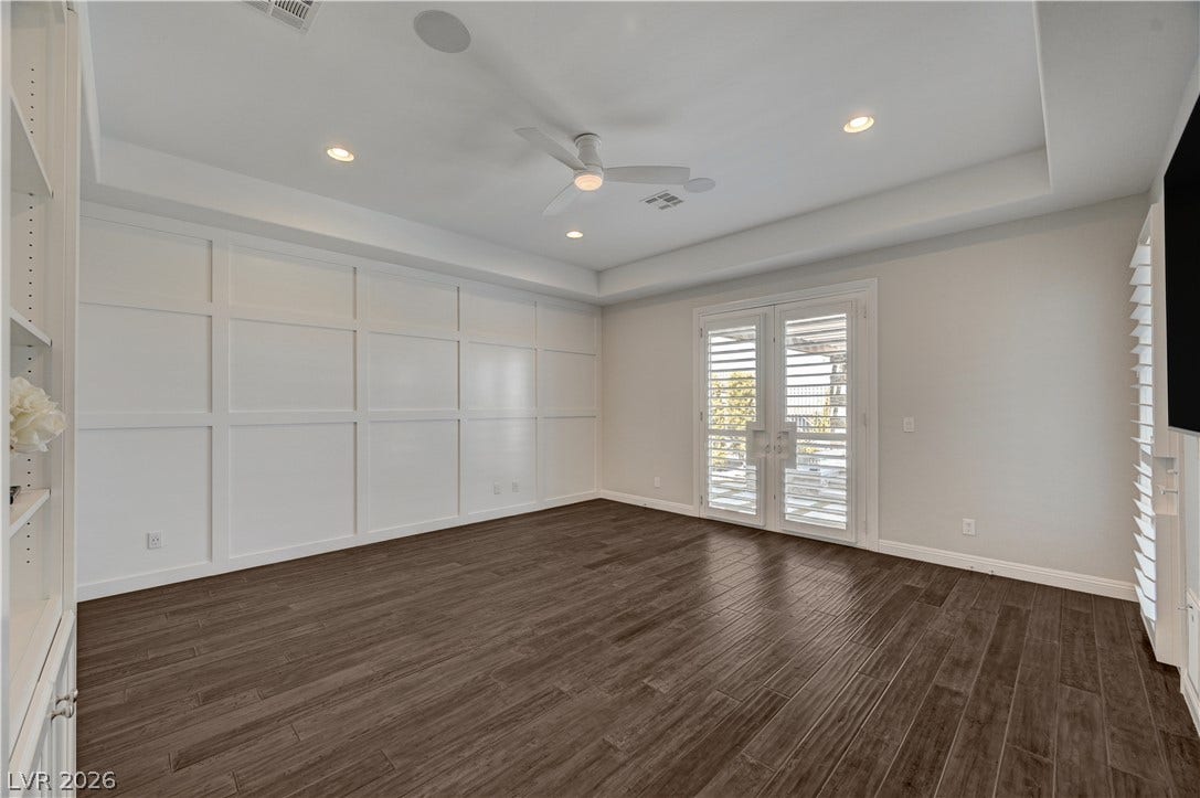 274 Evante Street, Las Vegas, NV 89138 Rich wood floors and textured wall detailing highlight this versatile living area with double glass doors.