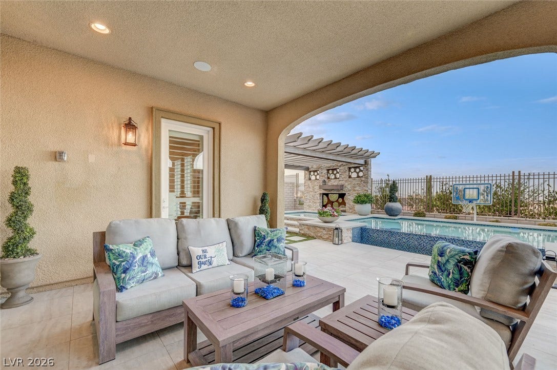 274 Evante Street, Las Vegas, NV 89138 An inviting covered patio offers seamless access to a private pool and outdoor living area, perfect for entertaining.