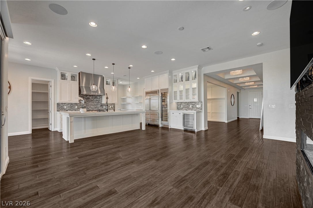 274 Evante Street, Las Vegas, NV 89138 Rich wood floors sweep through this expansive, open kitchen boasting built-in appliances and a massive island.