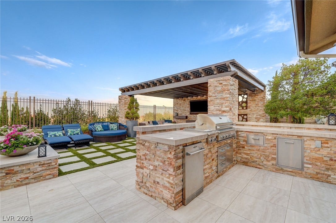 274 Evante Street, Las Vegas, NV 89138 An inviting outdoor kitchen area with a built-in grill and ample counter space for entertaining.