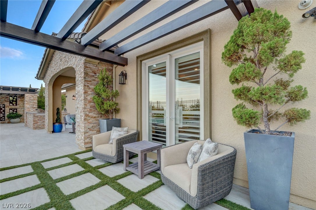 274 Evante Street, Las Vegas, NV 89138 An inviting outdoor oasis with a modern patio and architectural pergola.