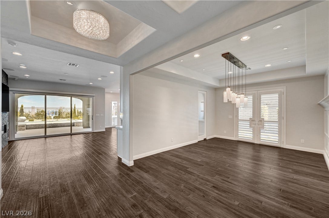 274 Evante Street, Las Vegas, NV 89138 Rich wood-look flooring and custom recessed tray ceilings define this open architectural layout.